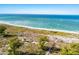 Aerial view of beach, boardwalk, and dune vegetation at 33 Seawatch Dr, Boca Grande, FL 33921