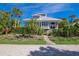 Charming two-story home with landscaped yard and a paved driveway at 33 Seawatch Dr, Boca Grande, FL 33921