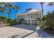 Two-story house with metal roof and paver driveway at 33 Seawatch Dr, Boca Grande, FL 33921