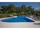 Community pool with lounge chairs and umbrellas at 33 Seawatch Dr, Boca Grande, FL 33921