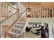 Open staircase with a wooden railing overlooking the living room at 33 Seawatch Dr, Boca Grande, FL 33921