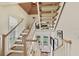 Elegant staircase with a wooden railing and carpeted steps at 33 Seawatch Dr, Boca Grande, FL 33921