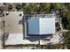 Aerial view of the home showcasing its metal roof, decks, and proximity to sandy areas at 331 Bocilla Dr, Placida, FL 33946