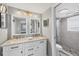 Bathroom with double vanity, granite counters, updated fixtures, and a walk-in shower at 331 Bocilla Dr, Placida, FL 33946