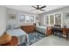 Comfortable bedroom with two twin beds, wood furnishings, and natural light from large windows at 331 Bocilla Dr, Placida, FL 33946