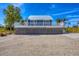Charming elevated beach house with a metal roof and a deck overlooking the landscape at 331 Bocilla Dr, Placida, FL 33946