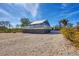 Inviting two-story beach house with a deck and seashell-covered yard, showcasing coastal charm at 331 Bocilla Dr, Placida, FL 33946