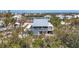 Charming two-story beach house with a screened porch, surrounded by lush greenery at 331 Bocilla Dr, Placida, FL 33946
