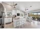 Bright white kitchen featuring stainless steel appliances and an island with bar seating at 331 Bocilla Dr, Placida, FL 33946