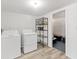 Well-organized laundry room with washer, dryer, shelving, and convenient storage space at 331 Bocilla Dr, Placida, FL 33946
