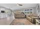 Open-concept living room with tile flooring, comfortable seating, and a seamless transition to an outdoor space at 331 Bocilla Dr, Placida, FL 33946