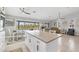 Open-concept living room with a large island and modern lighting fixtures at 331 Bocilla Dr, Placida, FL 33946
