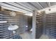 Private outdoor shower with wood slats, equipped with a sink and toilet for convenience at 331 Bocilla Dr, Placida, FL 33946