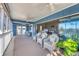 Inviting sunroom featuring comfortable wicker seating, ceiling fans, and large sliding glass doors at 331 Bocilla Dr, Placida, FL 33946