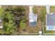 Aerial view of property highlighting the house, pool, large lot, and surrounding landscaping at 332 Comstock St, Port Charlotte, FL 33954