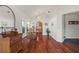 Dining room with wood floors, light walls, an arched window and stairs to the upper level at 332 Comstock St, Port Charlotte, FL 33954