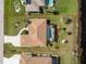 Aerial view of the property with a screened-in lanai, palm trees, and a well-maintained lawn at 35 Sportsman Pl, Rotonda West, FL 33947