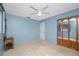 Bedroom featuring a ceiling fan, door and closet with mirrored doors at 36 Bunker Cir, Rotonda West, FL 33947