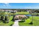 Aerial view of single-Gathering home with water access, lush landscaping, and neighborhood in background at 39 Tournament Rd, Rotonda West, FL 33947