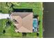 Aerial view showcasing home's layout, pool, and canal-front location at 39 Tournament Rd, Rotonda West, FL 33947