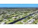 Broad aerial showcasing the community's layout, golf course, and water features at 39 Tournament Rd, Rotonda West, FL 33947