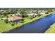 Aerial view of property highlighting canal-front position and surrounding landscape at 39 Tournament Rd, Rotonda West, FL 33947