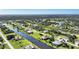 Wide aerial showcasing the community's canal, homes, and lush landscaping at 39 Tournament Rd, Rotonda West, FL 33947