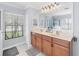 Spa-like bathroom with double vanity and large mirror at 39 Tournament Rd, Rotonda West, FL 33947