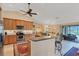 Open concept kitchen with stainless steel appliances and breakfast bar at 39 Tournament Rd, Rotonda West, FL 33947