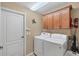 Bright laundry room with washer, dryer and cabinets at 39 Tournament Rd, Rotonda West, FL 33947