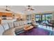 Large living room with a sectional sofa, access to pool and open floor plan at 39 Tournament Rd, Rotonda West, FL 33947