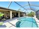 Enclosed pool area with canal views and patio furniture at 39 Tournament Rd, Rotonda West, FL 33947