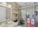 Bathroom featuring a glass door shower, light stone tiles, and decor shelves at 4072 Oakview Dr # C8, Punta Gorda, FL 33980