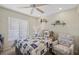 Bedroom with a white wicker bed frame, ceiling fan, and coastal-themed decor at 4072 Oakview Dr # C8, Punta Gorda, FL 33980