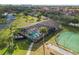 Aerial view of the community pool, jacuzzi, tennis courts, and verdant landscaping at 4072 Oakview Dr # C8, Punta Gorda, FL 33980