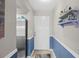 Entryway featuring blue wainscoting, a white door, and a stainless steel refrigerator at 4072 Oakview Dr # C8, Punta Gorda, FL 33980