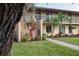 Attractive two-story condo featuring well-manicured landscaping, palm trees, and a charming exterior at 4072 Oakview Dr # C8, Punta Gorda, FL 33980