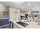 Bright kitchen island with stainless steel faucet and appliances with open view to the living spaces at 4072 Oakview Dr # C8, Punta Gorda, FL 33980
