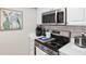 Stainless steel microwave and stove top with white cabinets and drawers, ready for cooking and preparing meals at 4072 Oakview Dr # C8, Punta Gorda, FL 33980