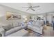 Bright and airy living room open to the kitchen with a ceiling fan and comfortable furniture at 4072 Oakview Dr # C8, Punta Gorda, FL 33980