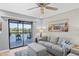Living room featuring lake view, with a comfortable seating area, and sliding glass door to balcony at 4072 Oakview Dr # C8, Punta Gorda, FL 33980