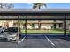 Assigned covered parking area for condo residents, and a view of the unit's manicured landscaping at 4072 Oakview Dr # C8, Punta Gorda, FL 33980