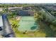 Aerial view of the tennis court, bocce court, swimming pool, and the building's exterior at 4072 Oakview Dr # C8, Punta Gorda, FL 33980