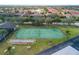 Aerial view of the community tennis court, bocce court, and well-maintained green space at 4072 Oakview Dr # C8, Punta Gorda, FL 33980