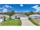 Property view showcasing a single-story house, driveway, and surrounding neighborhood at 5 Broadmoor Ln, Rotonda West, FL 33947