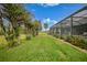 Landscaped backyard with lush green grass at 5 Broadmoor Ln, Rotonda West, FL 33947