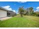 Side yard view with pool and fenced area at 5 Broadmoor Ln, Rotonda West, FL 33947