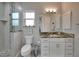 Bathroom with walk-in shower and granite countertop at 5 Broadmoor Ln, Rotonda West, FL 33947