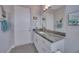 Bathroom with granite countertop and white cabinets at 5 Broadmoor Ln, Rotonda West, FL 33947
