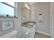 Small bathroom with granite countertop and white cabinets at 5 Broadmoor Ln, Rotonda West, FL 33947
